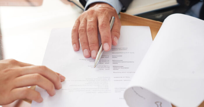 Close-up of business people examining business resume at the table during a job interview